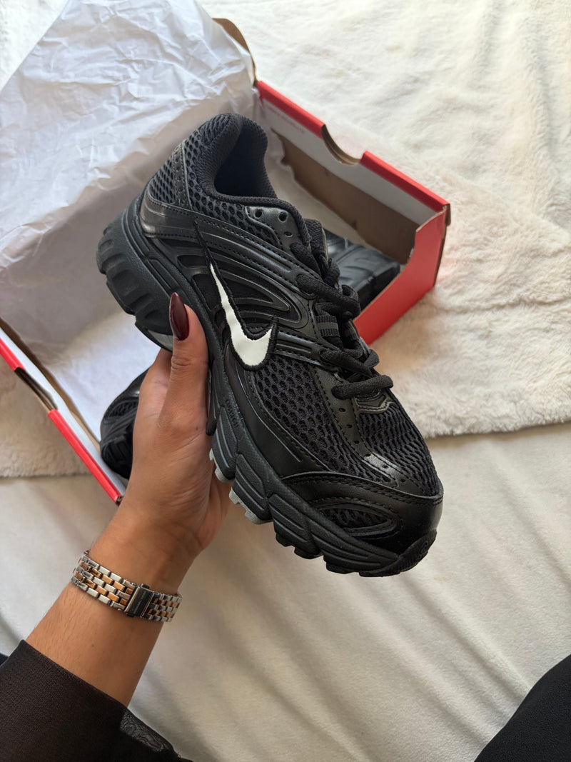 Black Nike running, white Swoosh, side view